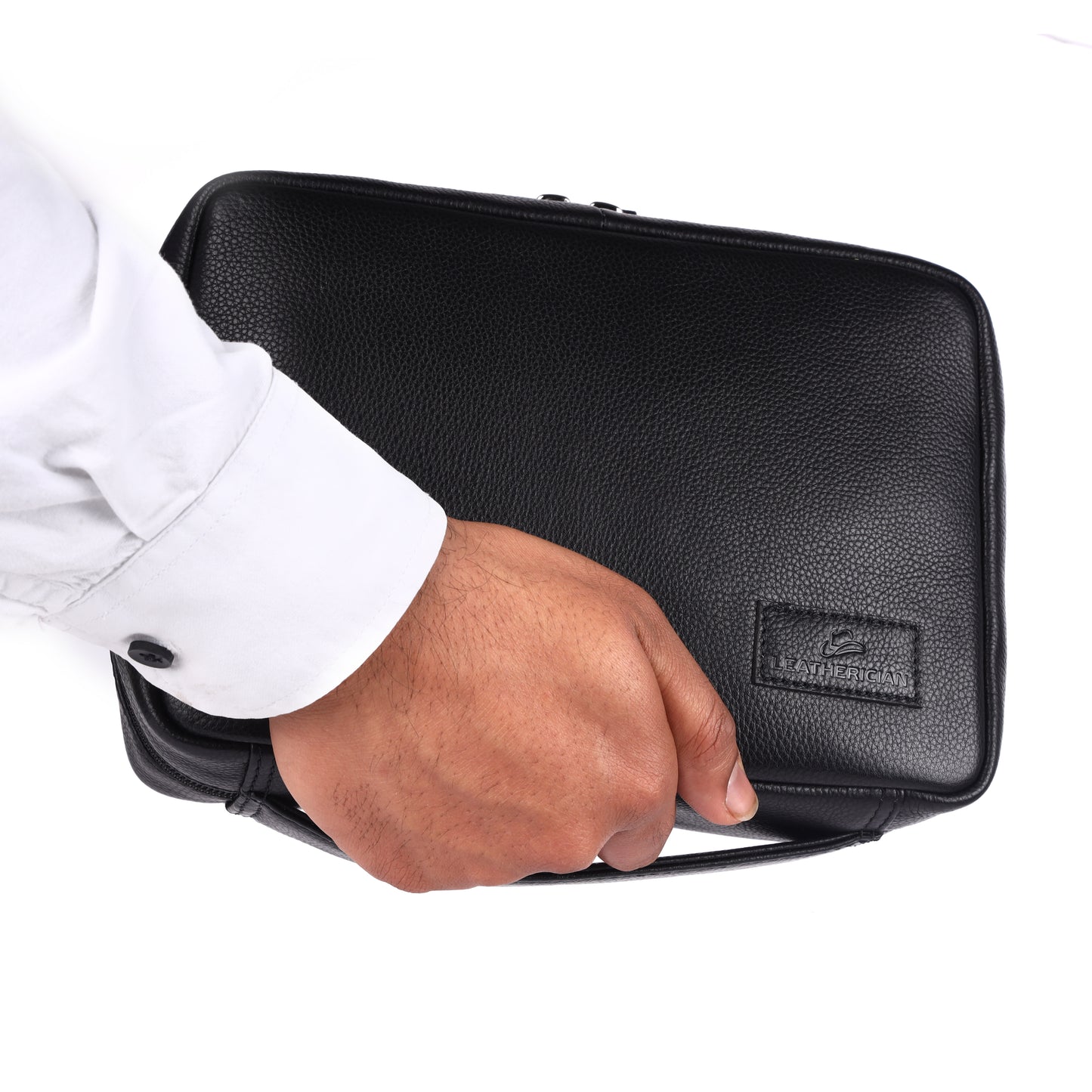 Hand holding a black leather briefcase with a visible brand logo on a white background
