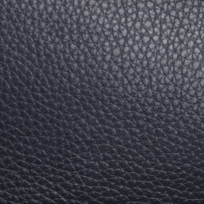 Close-up of a black leather bag with a brand logo on a white background
