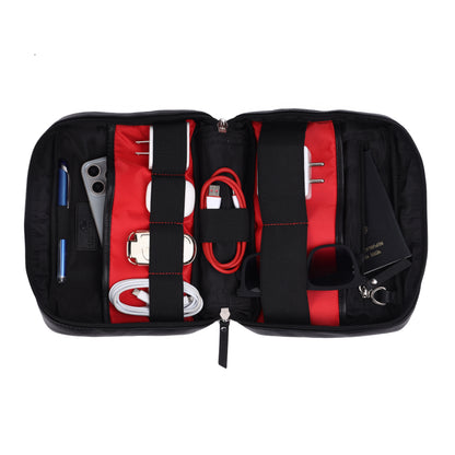 Black and red travel organizer with various items on a white background