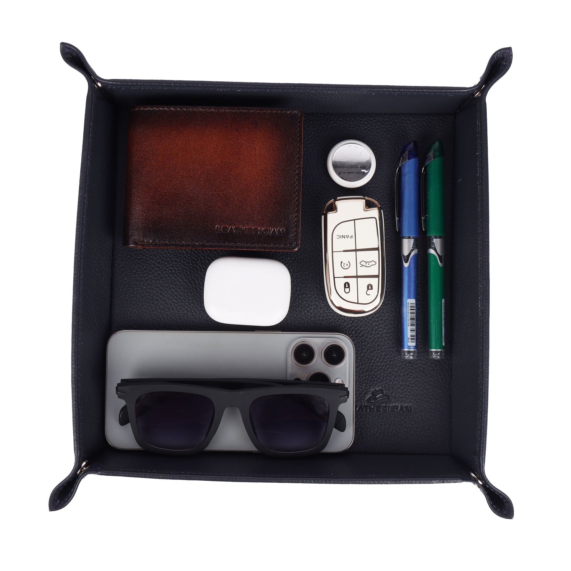 Black leather Valet Tray with various items including sunglasses, car keys, and pens.