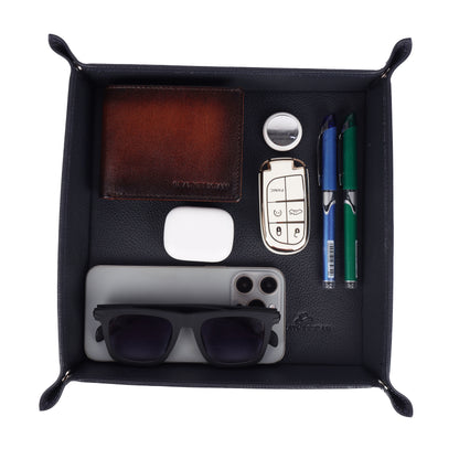 Black leather Valet Tray with various items including sunglasses, car keys, and pens.