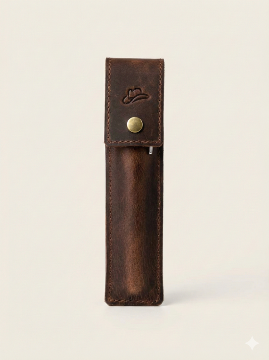 Brown leather pen holder with a gold button on a light beige background