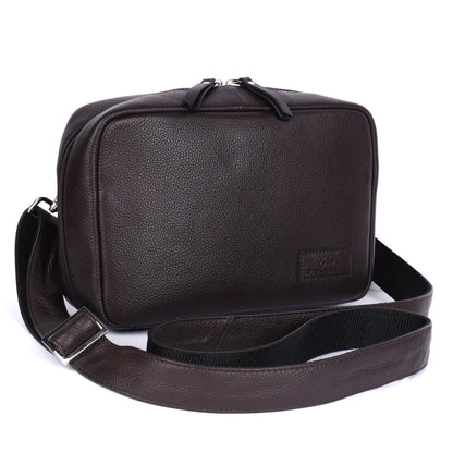Brown leather shoulder bag with a strap on a white background