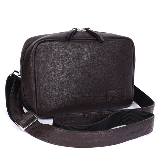 Brown leather shoulder bag with a strap on a white background