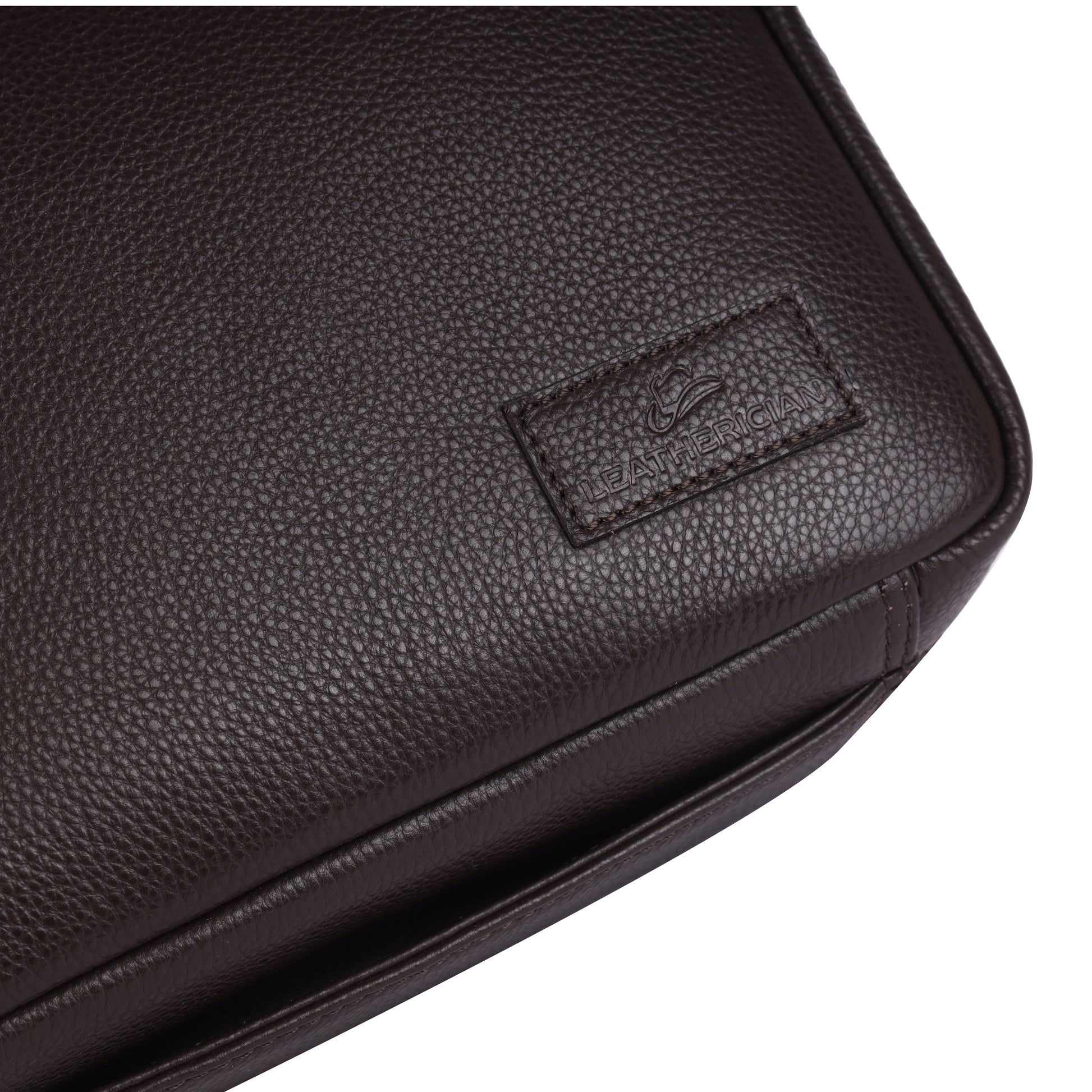Close-up of a black leather bag with a visible brand logo on a white background
