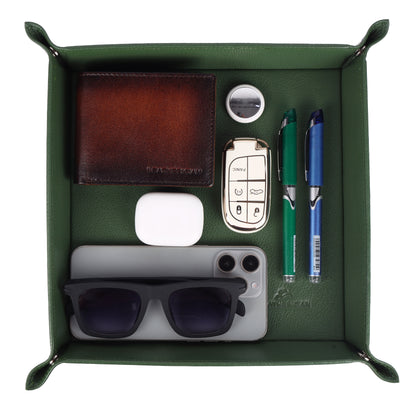 Green leather Valet Tray with various items including a wallet, phone, sunglasses, and pens.