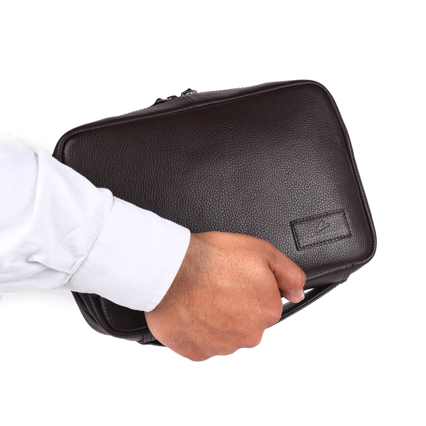 Hand holding a black leather briefcase with a visible brand logo on a white background