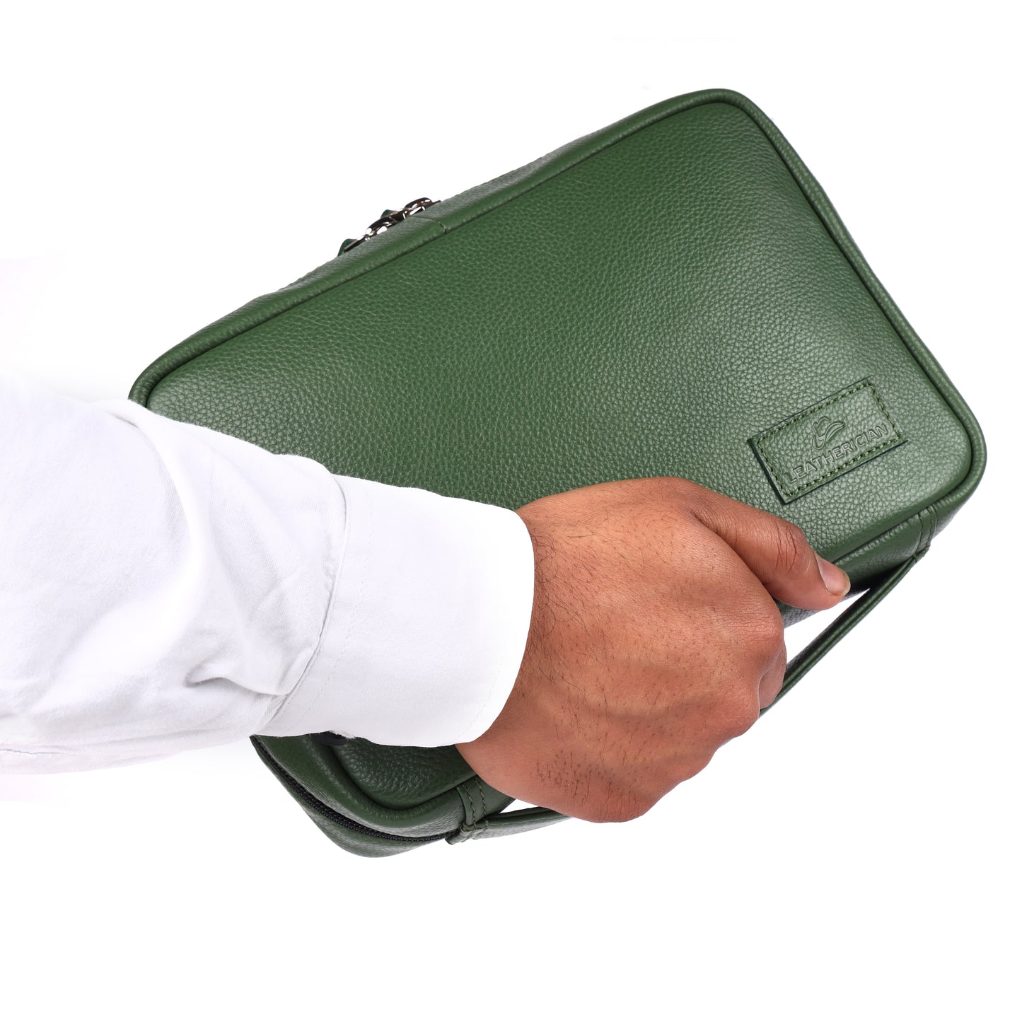 Hand holding a green leather briefcase with a visible brand logo on a white background
