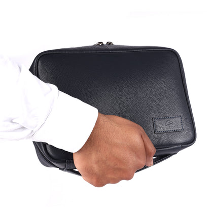 Hand holding a black leather briefcase on a white background