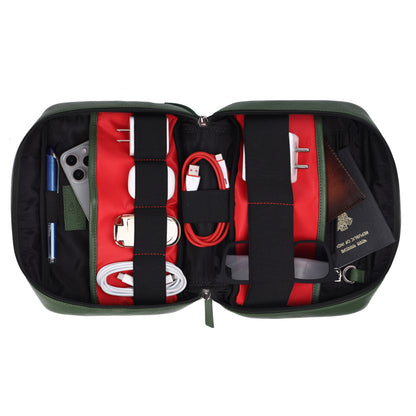 Open green travel bag with organized contents on a white background